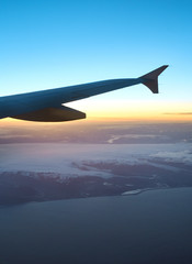 Fototapeta na wymiar View from airplane window on the sea and coastline in Iceland