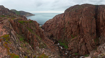 View on the rocky shore of the Barents sea. Kola Peninsula, The Arctic, Russia.