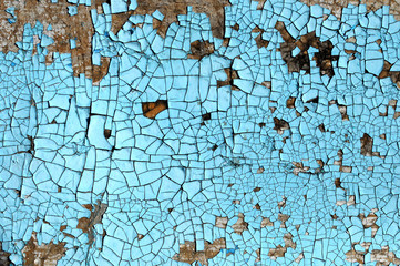 Rustic hardboard texture with scratches, cracks and blue peeling paint. Grunge background
