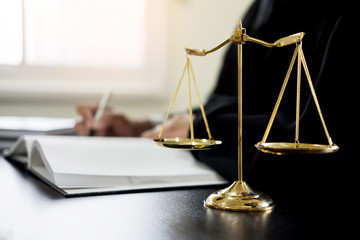 lawyer judge reading documents at desk in courtroom