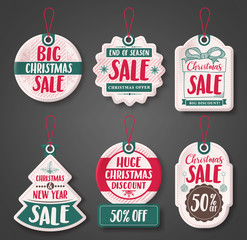 Christmas sale price tags vector set with different discount text and shapes of white paper cut label hanging for season promotion. Vector illustration.
