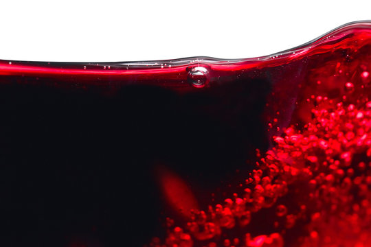 Abstract splashes of red wine on white background.