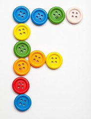 Fototapeta premium Sewing button alphabet: F