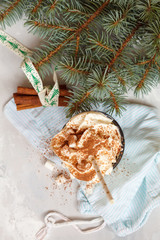 cocoa with cream and cinnamon on a concrete background