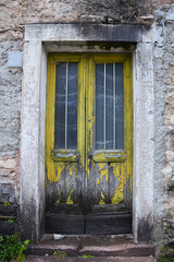 Fototapeta na wymiar An old door in an abandoned building in the hill village of Casso in Friuli Venezia Giulia, north east Italy.