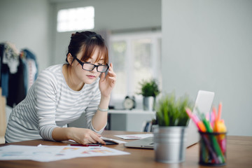 Beautiful young Asia woman working with laptop at home