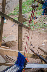 Traditional white and blue cloth for clothing being handwoven outside in Ivory Coast, West Africa