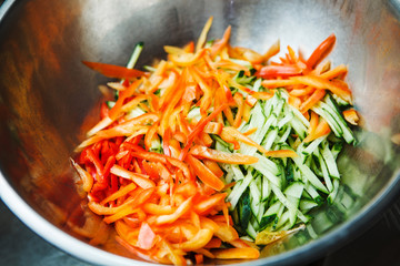 Finely chopped bell peppers, red tomatoes and green cucumbers