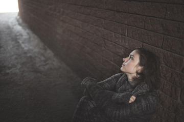 ordinary woman near a brick wall,  depression