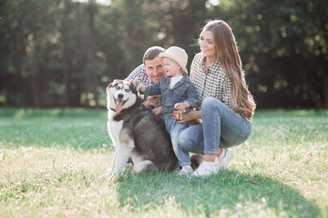 Naklejka na ściany i meble sunny pictures of a happy married couple with a dog and a child