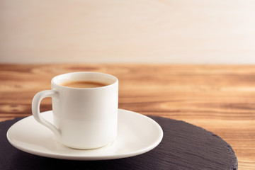 Cup of coffee espresso on wood background. Toned vintage