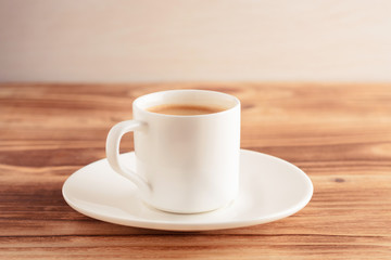 espresso cup of coffee on wooden background. Central composition. Vintage toned