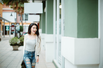 lifestyle fashion portrait of young stylish hipster Asia woman walking on street,wearing cute trendy outfit