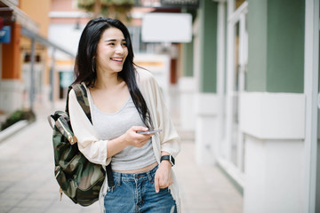Beautiful young Asia woman using a mobile phone
