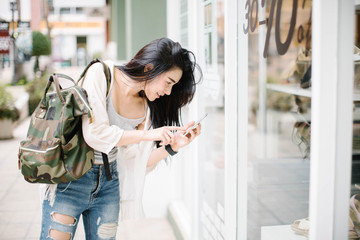 Beautiful young Asia woman using a mobile phone