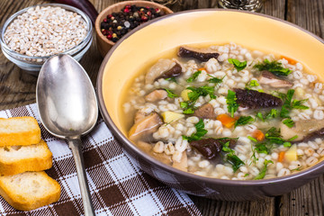 Soup with pearl barley and forest mushrooms
