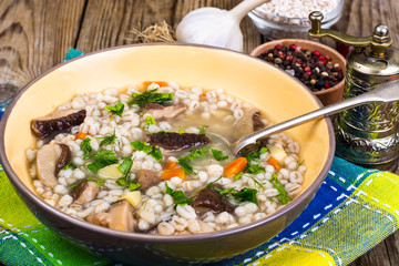 Soup with pearl barley and forest mushrooms