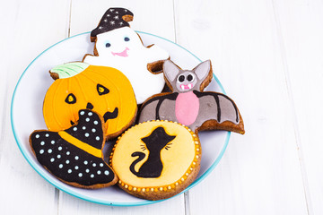 Funny delicious thematic homemade cookies with icing for Halloween on the wooden table