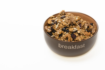 Breakfast: Bowl of whole grain muesli isolated on white background