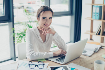 Development, authority, feminity concept. Pretty business woman is sitting at her light modern work...