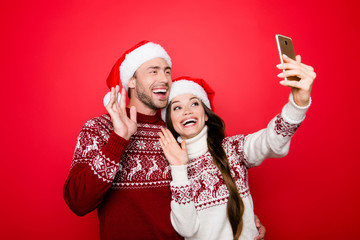 Hey! X mas video call, roaming, holy magic, winter, december, connection, noel concept. Cheerful husband and wife are photographers for their portrait, taking it on telephone smart pda, bonding