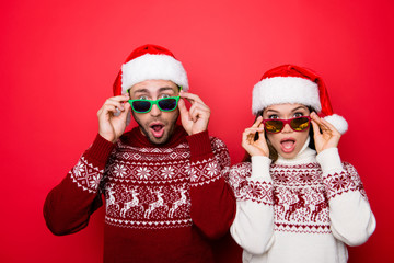 Omg! Increadible unbelievable crazy december surprise travel trips time! Holly jolly x mas! Closeup of excited astonished tourists with wide open eyes, mouthes, adjusting eye wear, noel costumes
