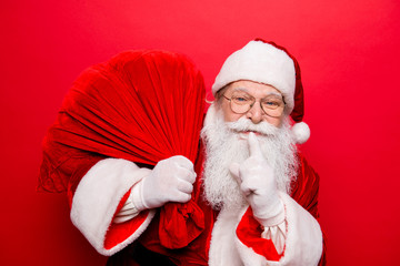 Shh! No sound mute silent confidential, privacy quiet, shush hissing hush concept. Funny santa in headwear, is gesturing keep forefinger by his lips. Holly jolly x mas noel miracles and magic time!