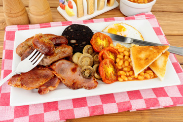 Traditional full English breakfast with sausages and bacon