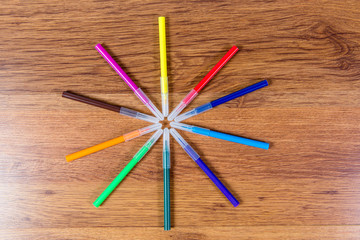 Fototapeta premium Colored markers lined in the form of sunlight. Highlighting. Art paint. Stationery.