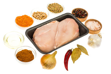 Fresh raw chicken breast with spices on white background