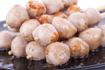 Grilled meat ball with sweet spicy sauce isolated on white.