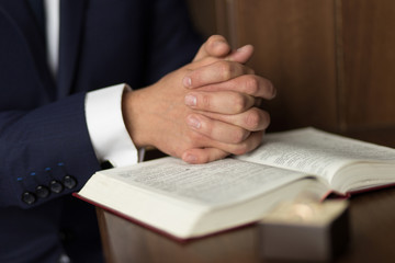 Male hands on Bible