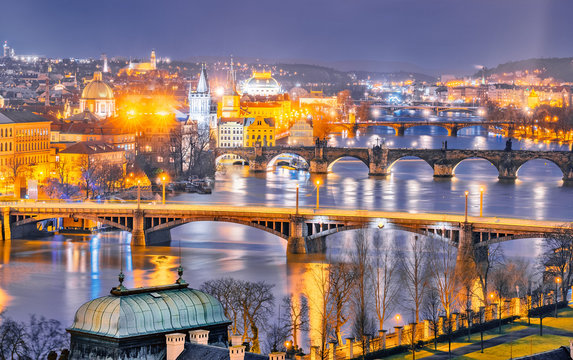 Classic panorama of Prague's bridges over Vltava river. Twilight scenery. Amazing view from above at old historical quarter. Prague, Czech Republic. Prague -famous and popular travel destination city.