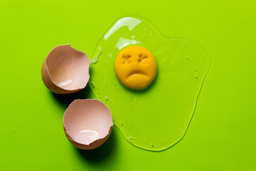 One chicken egg is broken and the yolk is sad or dead. Rotten egg