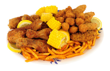 Plate of Southern fried chicken products with sweetcorn and fries