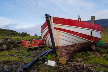 Red and white boats on beach