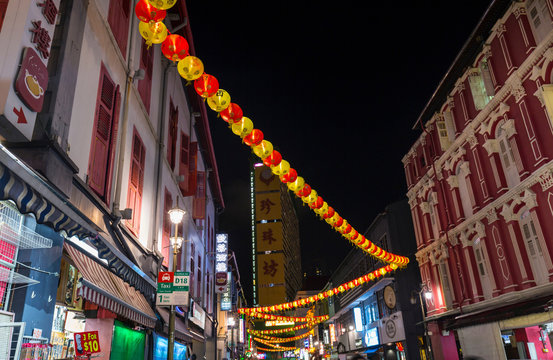 Paper lanterns and shopfronts in chinatown street at night, Singapore, South East Asia