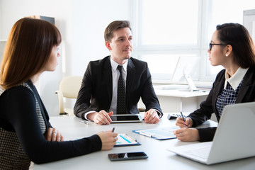 Young business people discussing a new project at a meeting