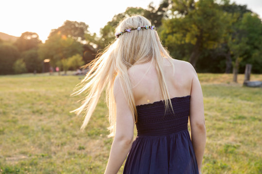 Rear view of woman in field wearing strapless dress