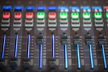 Slide the audio mixer in the control room.
