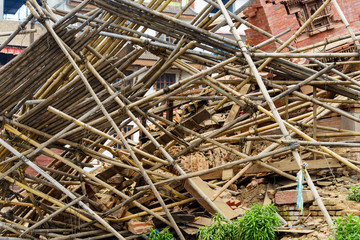 Aftermath of Nepal earthquake 2015, collapsed bamboo scaffolding and temple on Durbar Square in...
