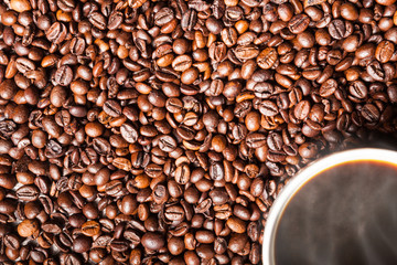 Coffee cup on coffee beans in close up photo. Refreshing beverage in the morning