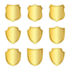 Gold shield shape icons set. 3D golden emblem signs isolated on white background. Symbol of security, power, protection. Badge shape shield graphic design Vector illustration