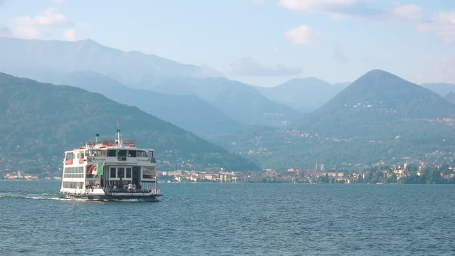Tourist boat in Italy. Maggiore lake, Stresa and mountains.