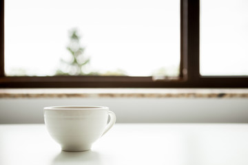 Coffee mug on a window sill. Morning coffee