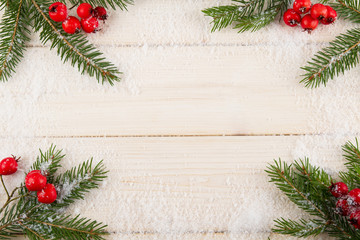 Christmas fir tree on white wooden background