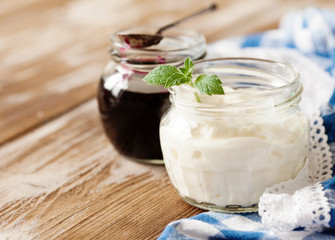 Fresh natural homemade yogurt on rustic wooden background