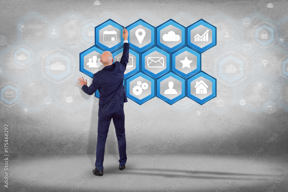 Poster businessman in front of a wall with application center displayed on a futuristic interface with tech