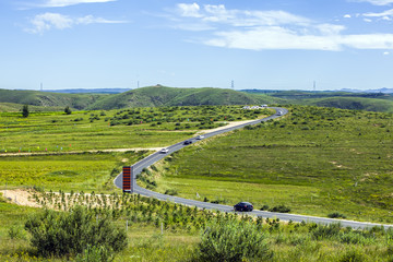 asphalt road on grassland