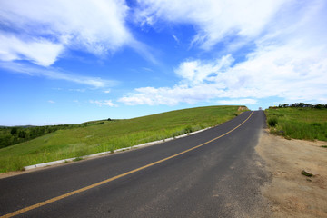 asphalt road on grassland